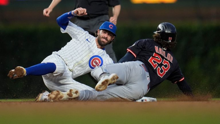 Chicago Cubs shortstop Dansby Swanson (7), left, catches Cleveland Guardians' Bo Naylor (23) stealing second during the fifth inning of a baseball game Thursday, July 3, 2025, in Chicago. (Erin Hooley/AP)