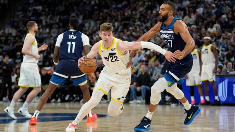 Utah Jazz forward Kyle Filipowski (22) works toward the basket as Minnesota Timberwolves center Rudy Gobert (27) defends during the first half of an NBA basketball game, Sunday, April 13, 2025, in Minneapolis. (Abbie Parr/AP)