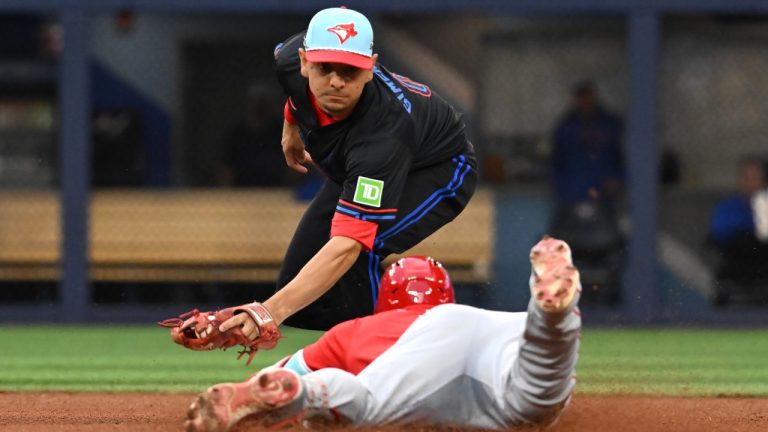 Los Angeles Angels' Jo Adell (7) slides safely into second base with a double ahead of the tag from Toronto Blue Jays second baseman Andres Gimenez in fifth inning MLB baseball action in Toronto. (Jon Blacker/CP)