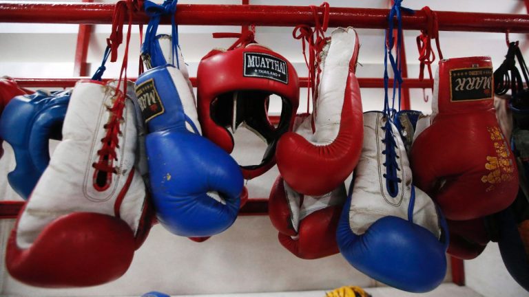 In this Wednesday, Nov. 14, 2018, photo, Thai kickboxing gloves and headgear hang at a training camp in Bangkok, Thailand. (Sakchai Lalit/AP)