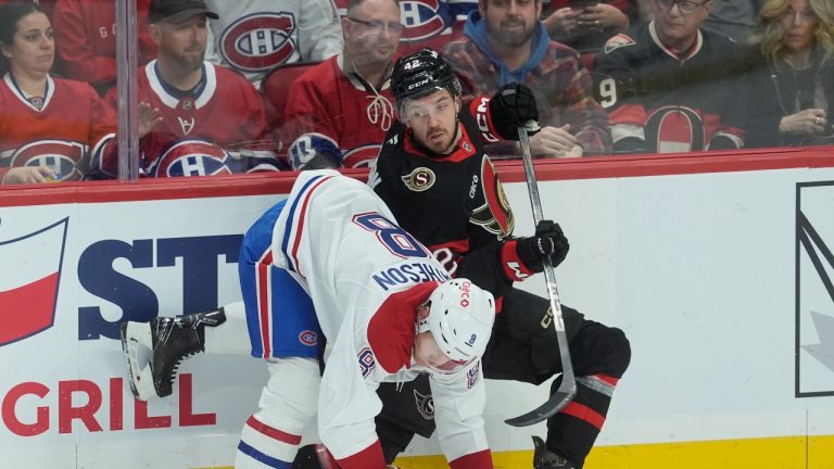 Montreal Canadiens' Mike Matheson (8) and Ottawa Senators' Hayden Hodgson (42) collide along the boards during first period NHL action in Ottawa., Friday April 11, 2025. (Adrian Wyld/THE CANADIAN PRESS)