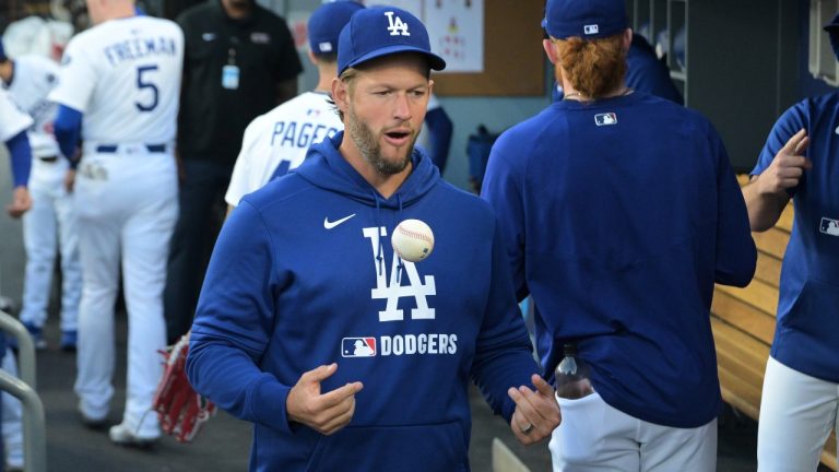 Los Angeles Dodgers' Clayton Kershaw tosses a ball as he walks through the dugout early in a baseball game against the Oakland Athletics, Wednesday, May 14, 2025, in Los Angeles. (Jayne Kamin-Oncea/AP)