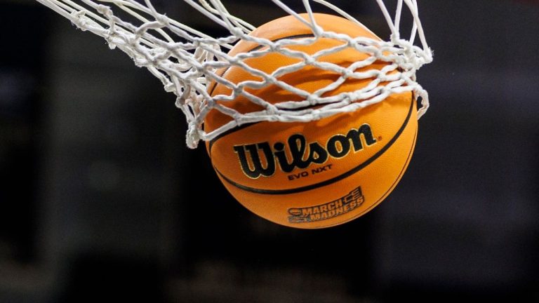  A basketball with a March Madness logo is seen going through a net prior to a second round of the NCAA college basketball tournament between Notre Dame and Michigan, March 23, 2025, in South Bend, Ind. (John Mersits/AP)