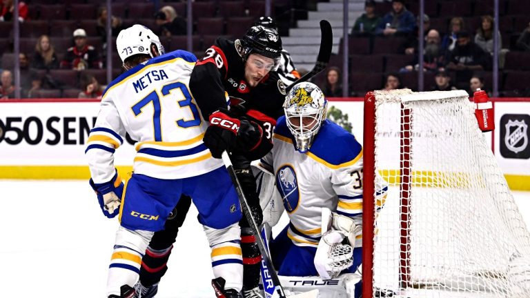 Ottawa Senators' Zack Ostapchuk (38) tries to get his stick on a rebound from between Buffalo Sabres' Zach Metsa (73) and goaltender Felix Sandstrom (32) during second period pre-season NHL hockey action in Ottawa, on Thursday, Sept. 26, 2024. (Justin Tang/THE CANADIAN PRESS)
