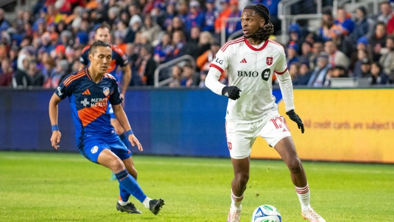 Toronto FC defender Zane Monlouis (12) looks for an open teammate during the first half of an MLS soccer match against FC Cincinnati, Saturday, March 8, 2025, in Cincinnati. (Tanner Pearson/AP)