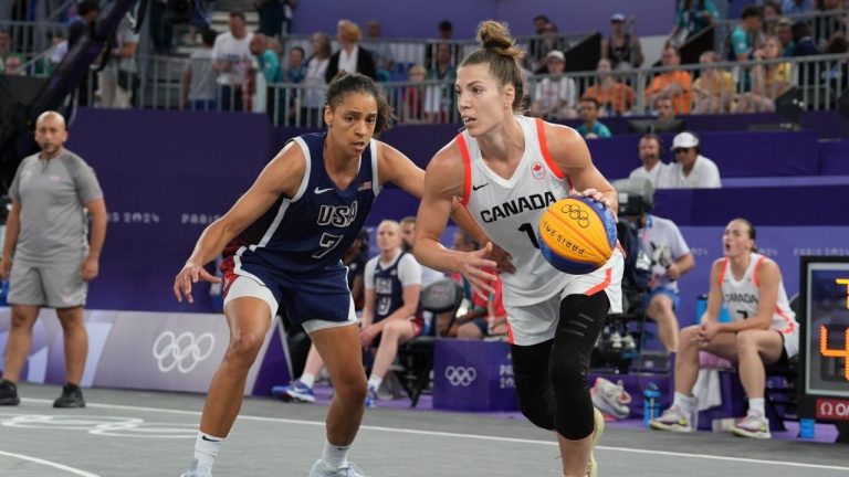 Canada's Michelle Plouffe (1) moves past United States Cierra Burdick (7) during the women's 3X3 basketball bronze medal game at the Summer Olympics in Paris on Monday, Aug. 5, 2024. (Adrian Wyld/CP)