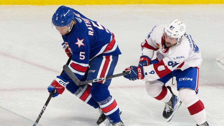 Laval Rockets' Xavier Simoneau (81) battles Rochester Americans' Jack Rathbone (5) during third period AHL hockey action in Laval, Que., on Wednesday, Nov. 20, 2024. (Christinne Muschi/CP)