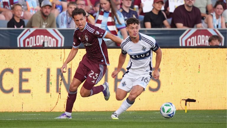 Colorado Rapids midfielder Cole Bassett (23) and Vancouver Whitecaps midfielder Sebastian Berhalter (16) in the first half of an MLS soccer match Saturday, July 12, 2025, in Commerce City, Colo. (David Zalubowski/AP)