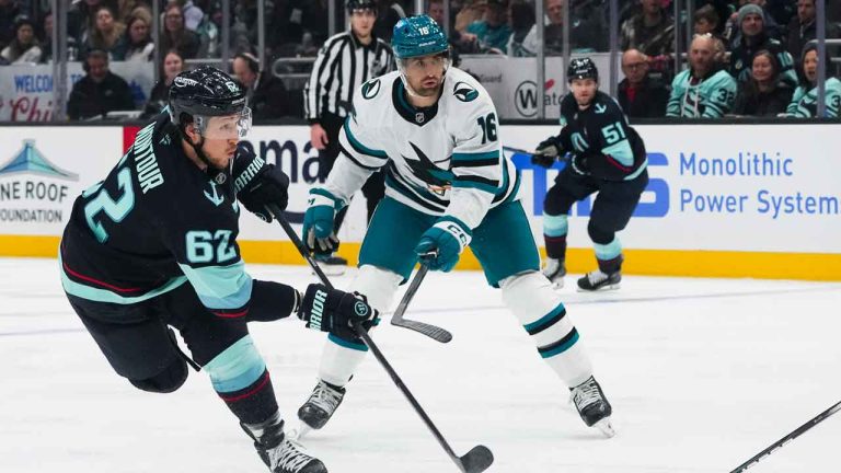 Seattle Kraken defenseman Brandon Montour (62) shoots and scores as San Jose Sharks center Colin White (16) looks on during an NHL hockey game. (Lindsey Wasson/AP)
