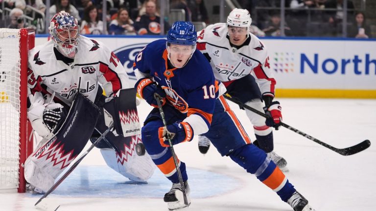 New York Islanders' Simon Holmstrom (10) fights for control of the puck with with Washington Capitals goaltender Charlie Lindgren (79) and Martin Fehérváry (42) during the second period of an NHL hockey game Tuesday, April 15, 2025, in Elmont, N.Y. (Frank Franklin II/AP)