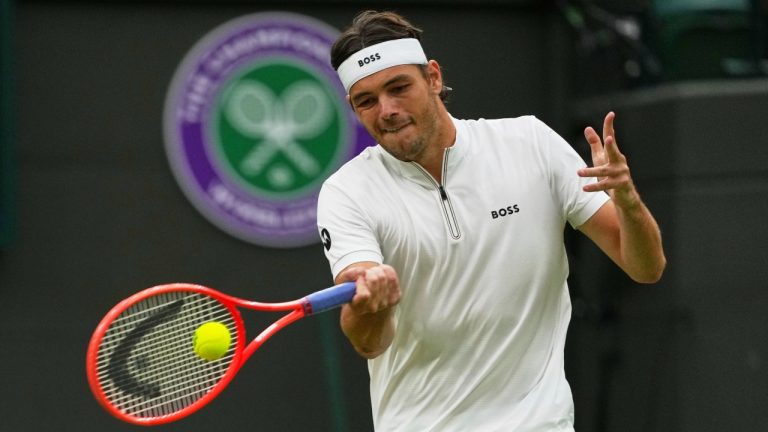 Taylor Fritz of the U.S. plays a return to Jordan Thompson of Australia during their men's singles fourth round match at the Wimbledon Tennis Championships in London, Sunday, July 6, 2025.(Joanna Chan/AP)