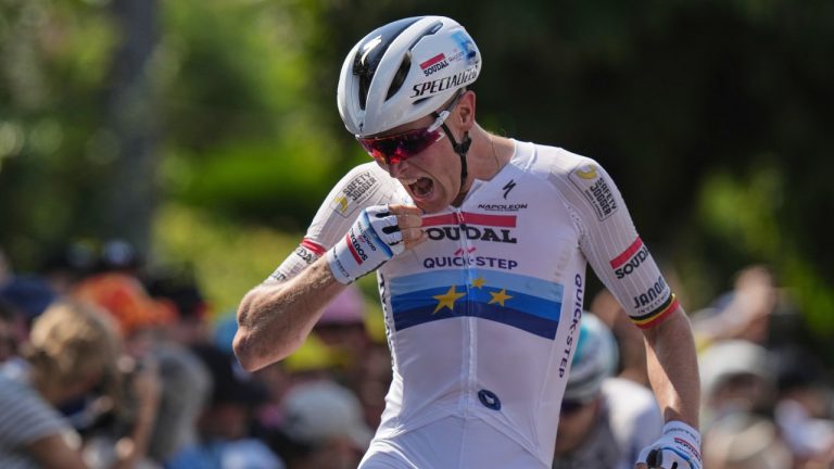 Stage winner Belgium's Tim Merlier celebrates as he crosses the finish line of the ninth stage of the Tour de France cycling race over 174.1 kilometers (108 miles) with start in Chinon and finish in Chateauroux, France, Sunday, July 13, 2025. (Thibault Camus/AP)