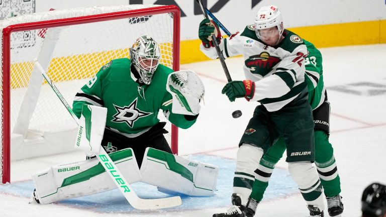 Dallas Stars goaltender Jake Oettinger (29) reaches out to grab a shot under pressure from Minnesota Wild center Travis Boyd (72) in the second period of a preseason NHL hockey game Wednesday, Sept. 25, 2024, in Dallas. (Tony Gutierrez/AP)