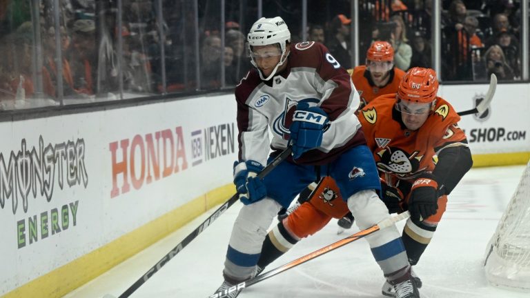 Colorado Avalanche centre T.J. Tynan (9) passes the puck away from the pressure from Anaheim Ducks right wing Sam Colangelo (64) during the first period of an NHL hockey game in Anaheim, Calif., Sunday, April 13, 2025. (Alex Gallardo/AP Photo)