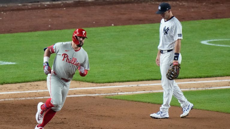 New York Yankees first base Paul Goldschmidt, right, reacts as Philadelphia Phillies' Kyle Schwarberruns the bases after hitting a two-run home run during the eighth inning of a baseball game Friday, July 25, 2025, in New York. (Frank Franklin II/AP)