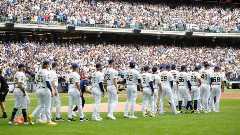 Milwaukee Brewers players walk onto the field for the ceremonial first pitch during the Bob Uecker Celebration of Life before a baseball game against the San Francisco Giants, Sunday, Aug. 24, 2025, in Milwaukee. (Jeffrey Phelps/AP)