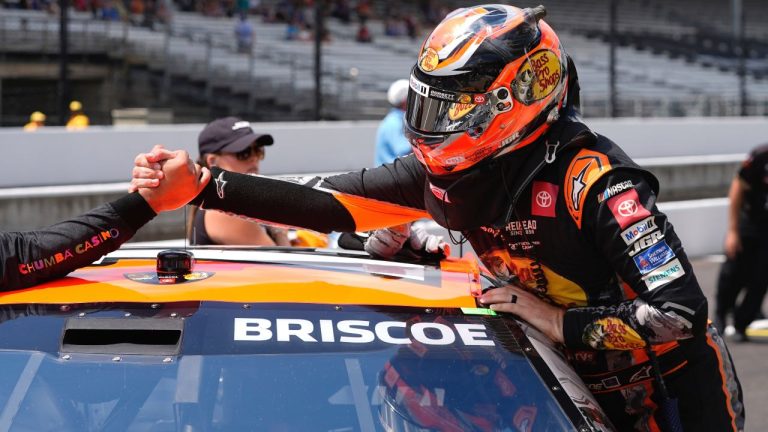 Chase Briscoe is congratulated by a crew member after winning the pole for the NASCAR Cup Series auto race at Indianapolis Motor Speedway, Saturday, July 26, 2025, in Indianapolis. (AP/Darron Cummings)