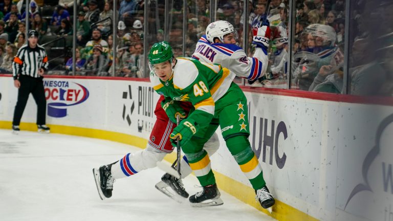 New York Rangers' Tyler Pitlick and Minnesota Wild defenceman Daemon Hunt battle for control of the puck during the second period of an NHL game Saturday, Nov. 4, 2023, in St. Paul, Minn. (Craig Lassig/AP)