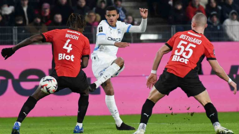 Marseille's Mason Greenwood, center, passes the ball as Rennes' Christopher Wooh and Leo Ostigard try to block during the French League One soccer match between Rennes and Marseille in Rennes, France, Saturday Jan. 11, 2025. (Mathieu Pattier/AP)