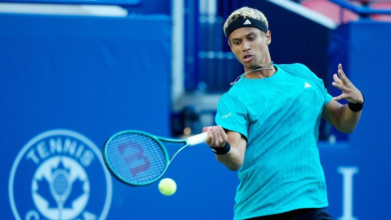 Gabriel Diallo, of Canada, returns a forehand to Taylor Fritz, of the United States of America, during their match at the National Bank Open in Toronto, Friday, Aug. 1, 2025. (Frank Gunn/CP)