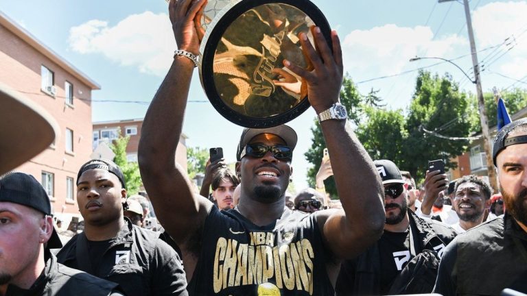 Oklahoma City Thunder guard Luguentz Dort, centre, carries the NBA's Larry O'Brien trophy through the streets of Montreal North, Thursday, Aug. 21, 2025. (Graham Hughes/CP)