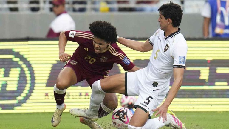Venezuela's Eduard Bello, left, and Bolivia's Efrain Morales vie for the ball during a World Cup 2026 qualifying soccer match in Maturin. (Ariana Cubillos/AP)