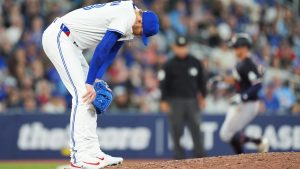 Toronto Blue Jays pitcher Jeff Hoffman (left) reacts on the mound after giving up a three-run home run to Minnesota Twins' Matt Wallner (back right) during ninth inning MLB baseball action in Toronto on Tuesday, August 26, 2025. (Frank Gunn/CP)