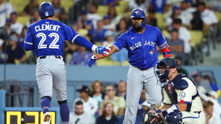 Toronto Blue Jays' Ernie Clement (22) celebrates with designated hitter Vladimir Guerrero Jr. (27) after hitting a home run as Los Angeles Dodgers catcher Dalton Rushing (68) watches during the eighth inning of a baseball game, Saturday, Aug. 9, 2025, in Los Angeles. (Jessie Alcheh/AP)