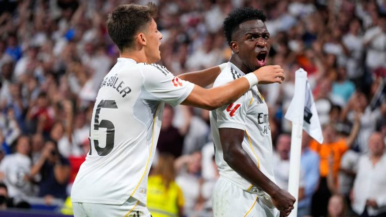 Real Madrid's Vinicius Junior, right, celebrates with Arda Guler after scoring his side's second goal during the Spanish La Liga soccer match between Real Madrid and Mallorca in Madrid, Saturday, Aug. 30, 2025. (Manu Fernandez/AP)