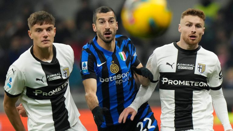 Inter Milan's Henrikh Mkhitaryan, centre, Parma's Giovanni Leoni, left, and Parma's Antoine Hainaut vie for the ball during the Serie A soccer match between Inter Milan and Parma at the San Siro stadium in Milan, Italy, Friday, Dec. 6, 2024. (Luca Bruno/AP)