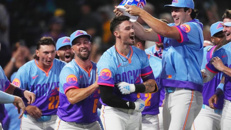 Colorado Rockies' Brenton Doyle, third from left, celebrates after hitting a two-run, walkoff home run with teammates, from left, Jordan Beck, Kyle Farmer and Michael Toglia in the ninth inning of a baseball game against the Pittsburgh Pirates Friday, Aug. 1, 2025, in Denver. (David Zalubowski/AP)