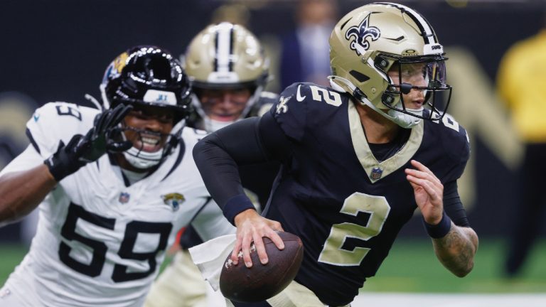 New Orleans Saints quarterback Spencer Rattler (2) scrambles past Jacksonville Jaguars defensive end Myles Cole (59) in the second half of an NFL pre-season football game in New Orleans, Sunday, Aug. 17, 2025. (Butch Dill/AP)
