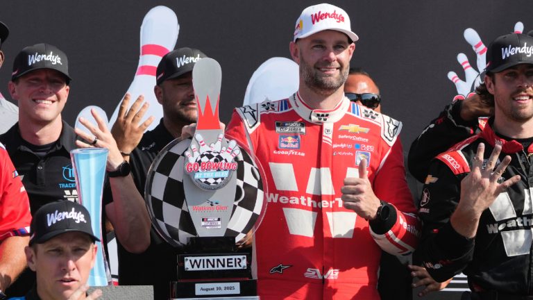 Shane van Gisbergen, centre right, poses for pictures with his team after finishing first during a NASCAR Cup Series auto race in Watkins Glen, N.Y., Sunday, Aug. 10, 2025. (Seth Wenig/AP)