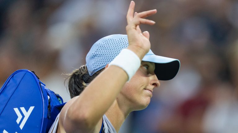 Iga Swiatek of Poland waves to the crowd following her loss to Clara Tauson of Denmark during round of 16 tennis action at the National Bank Open in Montreal, Sunday, Aug. 3, 2025. (Christinne Muschi/CP)