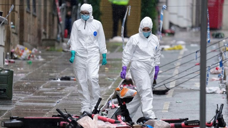 Forensic officers examine the site where a 53-year-old British man plowed a minivan into a crowd of Liverpool soccer fans who were celebrating the city's Premier League championship Monday, injuring more than 45 people in Liverpool, England, Tuesday, May 27, 2025. (AP Photo/Jon Super, File)