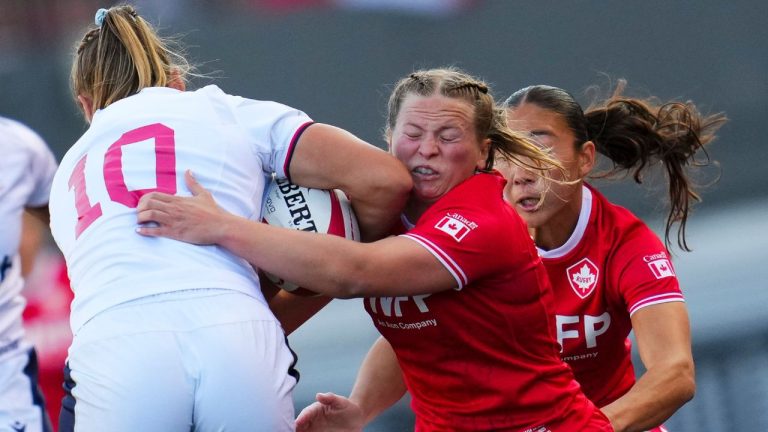 Canada's Claire Gallagher (10), second from right, tackles USA's McKenzie Hawkins (10) during the first half of Women's rugby action in Ottawa on Aug. 1, 2025. THE CANADIAN PRESS/Sean Kilpatrick