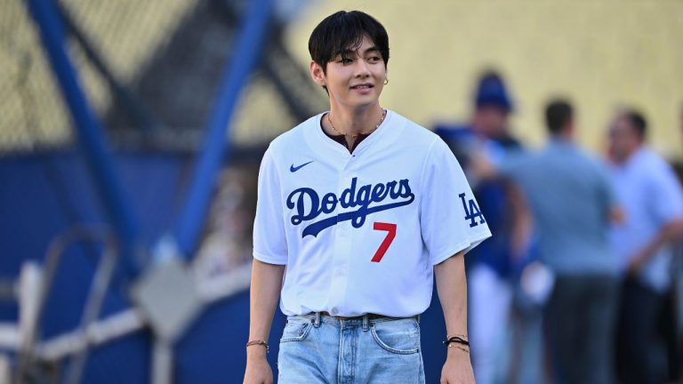 V, a member of the South Korean K-pop band BTS, looks on during batting practice before a baseball game between the Los Angeles Dodgers and the Cincinnati Reds Monday, Aug. 25, 2025, in Los Angeles. (Jayne Kamin-Oncea/AP)
