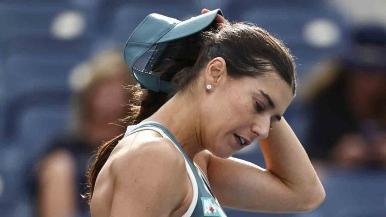Soraya Cirstea, of Romania, pulls off her visor after losing to Karolina Muchova, of the Czech Republic, during the second round of the U.S. Open tennis championships, Thursday, Aug. 28, 2025, in New York. (Andres Kudacki/AP)