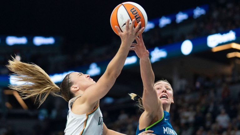Minnesota Lynx forward Alanna Smith (8) blocks a lay-up attempt by New York Liberty guard Sabrina Ionescu (20) late in the fourth quarter of a WNBA basketball game Saturday, Aug. 16, 2025, in Minneapolis. (Alex Kormann/Star Tribune via AP)