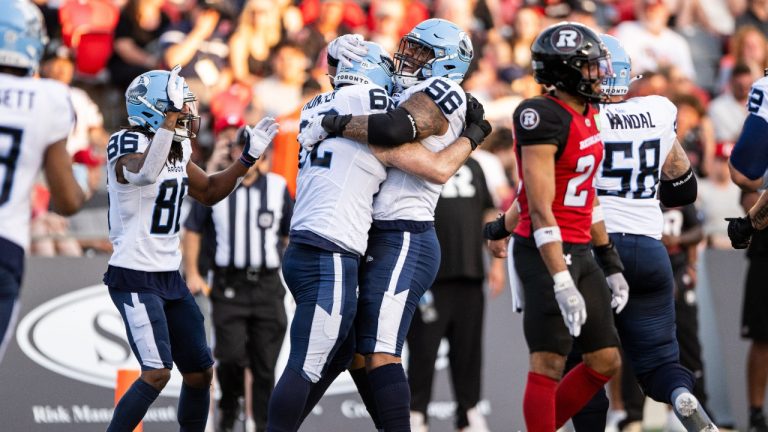 Toronto Argonauts offensive lineman George Moore (56) celebrates his touchdown with teammates during first half CFL football action against the Ottawa Redblacks in Ottawa, on Sunday, June 29, 2025. (Spencer Colby/CP)