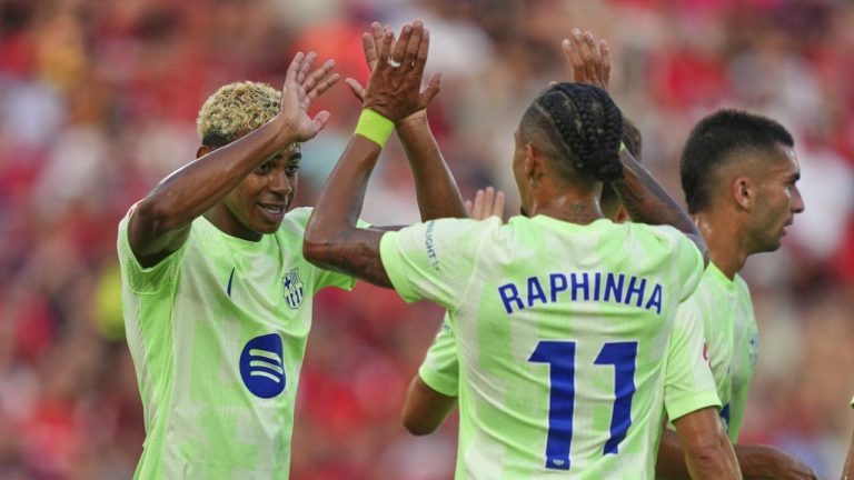 Barcelona's Lamine Yamal left, and Raphinha celebrate after a goal during the La Liga soccer match between Mallorca and Barcelona in Mallorca, Spain, Saturday, Aug. 16, 2025. (Joan Mateu Parra/AP)