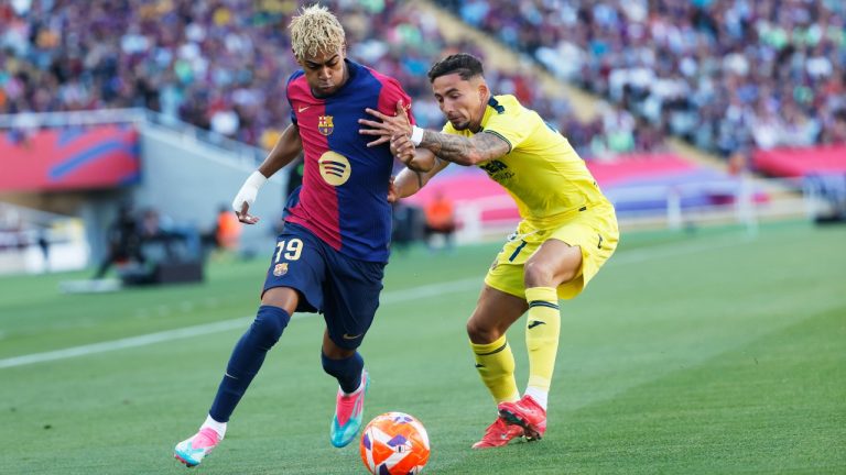 Barcelona's Lamine Yamal, left, and Villarreal's Yeremy Pino challenge for the ball during the Spanish La Liga soccer match between Barcelona and Villarreal at Lluis Companys Olympic Stadium in Barcelona, Spain, Sunday, May 18, 2025. (Joan Monfort/AP)