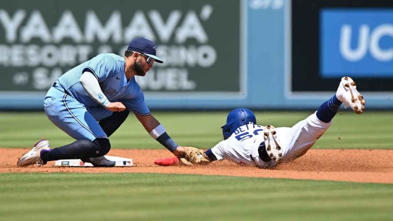 Los Angeles Dodgers' Mookie Betts, right, is tagged out by Toronto Blue Jays shortstop Bo Bichette, left, on a steal-attempt during the first inning of a baseball game. (Wally Skalij/AP)