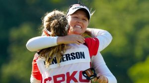 Brooke Henderson of Canada, right, hugs her caddie sister Brittany Henderson as she after winning the Canadian Women's Open on the 18th hole at Mississauga Golf and Country Club in Mississauga, Ontario on Sunday August 24, 2025. (Frank Gunn/CP)