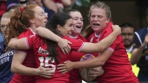 Alysha Corrigan of Canada, second right, holds the ball as she celebrates with teammates after scoring a try during the pool B match at the 2025 Women's Rugby World Cup between Canada and Wales, in Manchester. (Dave Shopland/AP)