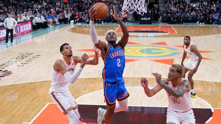 Oklahoma City Thunder guard Shai Gilgeous-Alexander (2) drives to the basket against San Antonio Spurs center Victor Wembanyama, left, and forward Jeremy Sochan (10) during the second half of an NBA basketball game in San Antonio, Wednesday, Jan. 24, 2024. (Eric Gay/AP)