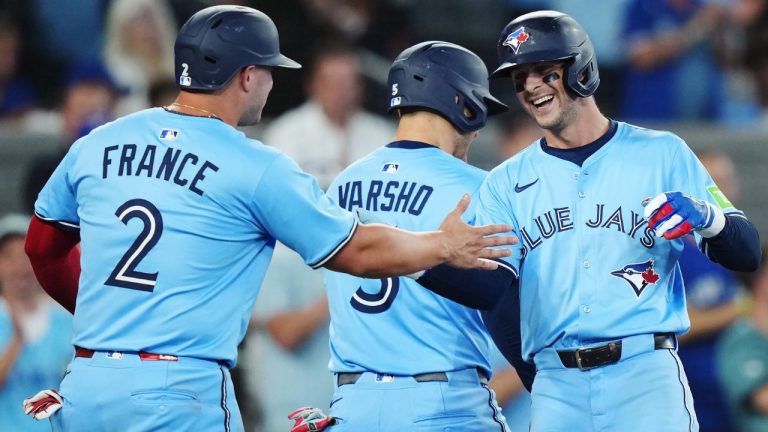 Toronto Blue Jays' Ernie Clement (right) celebrates his three-run home run against the Chicago Cubs with Ty France (2) and Daulton Varsho (5) during fourth inning MLB baseball action in Toronto on Tuesday, August 12, 2025. (Nathan Denette/THE CANADIAN PRESS)
