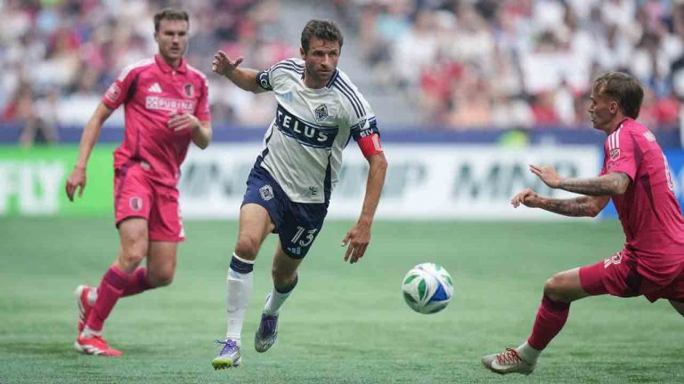 Vancouver Whitecaps Thomas Muller, centre, and St. Louis City's Conrad Wallem, right, vie for the ball during the first half of an MLS soccer match, in Vancouver, on Saturday, Aug. 23, 2025. (Darryl Dyck/CP)