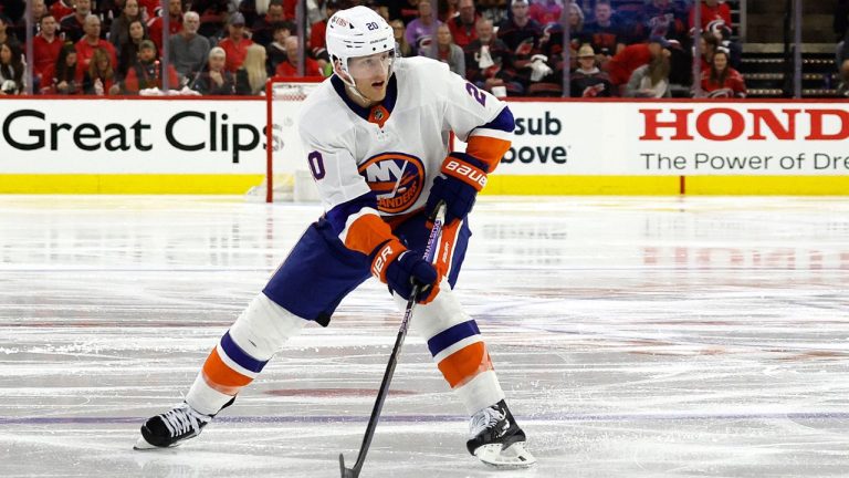 New York Islanders' Hudson Fasching (20) moves the puck against the Carolina Hurricanes during the third period in Game 1 of an NHL hockey Stanley Cup first-round playoff series in Raleigh, N.C., Saturday, April 20, 2024. (Karl B DeBlaker/AP)