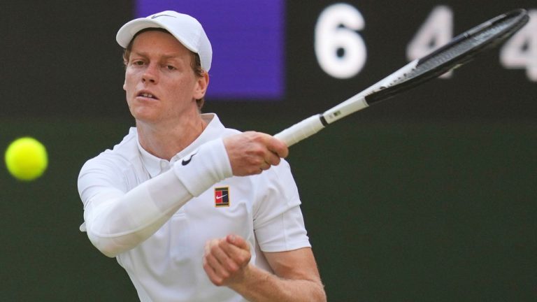 Italy's Jannik Sinner returns to Carlos Alcaraz of Spain in the men's singles final at the Wimbledon Tennis Championships in London, Sunday, July 13, 2025. (Kin Cheung/AP)